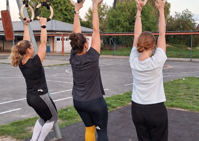 3 Frauen üben das Hängen an Ringen
